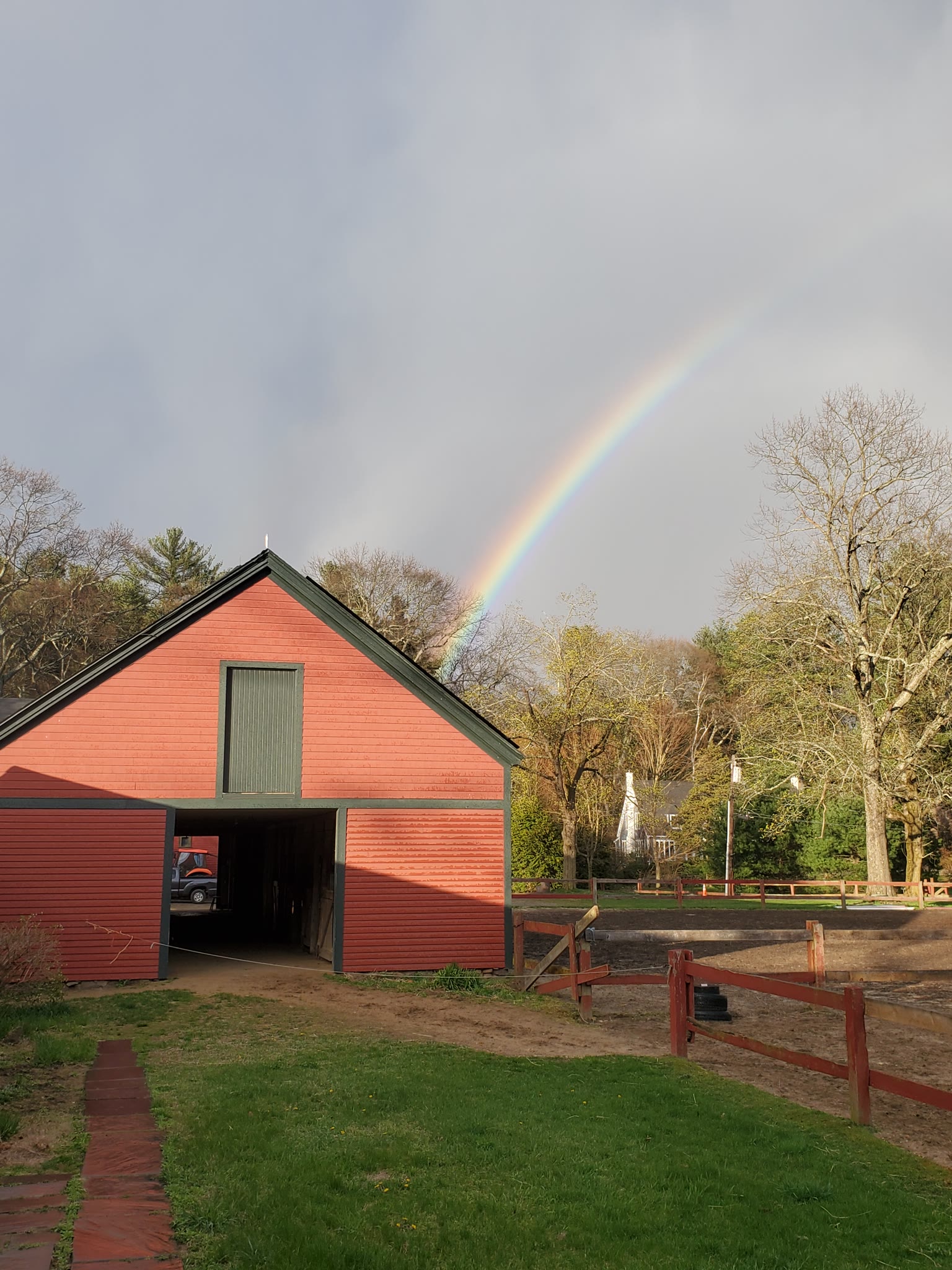 A red barn under a rainbow